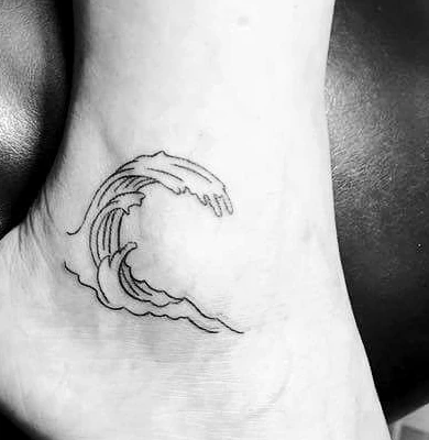 A small fine-line breaking wave tattooed on an ankle.